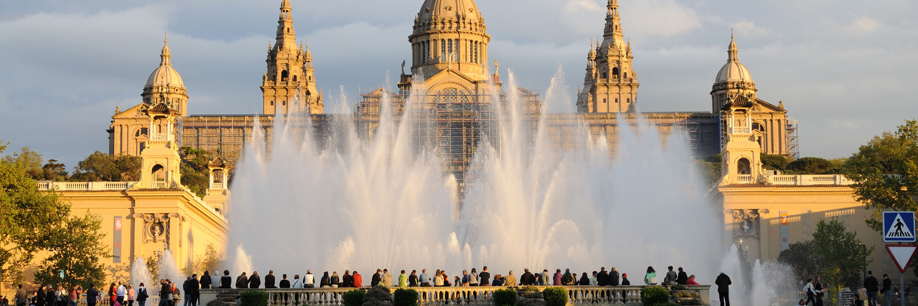 Large, ornate building with a fountain in front in Barcelona 