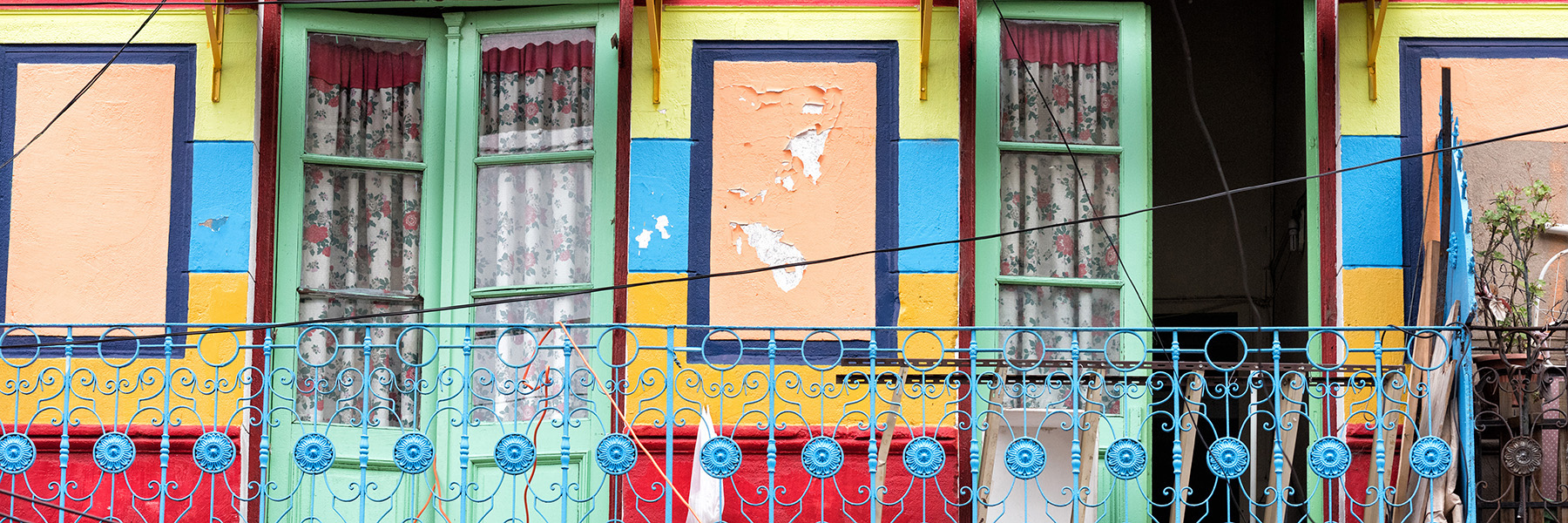 Colorful building front with decorative windows and doors 