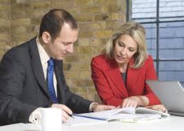 Man and lady looking at papers