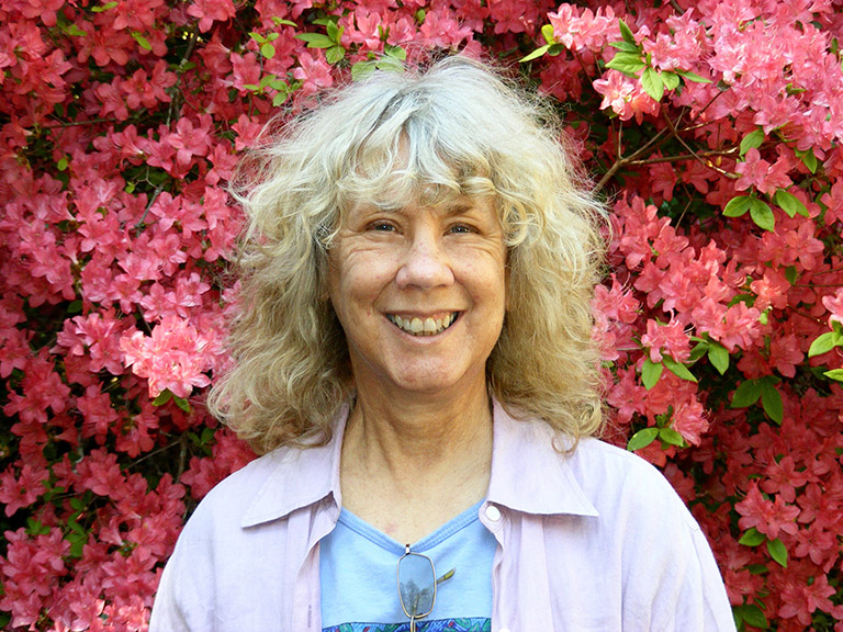 Linda Davidson portrait with flowers.