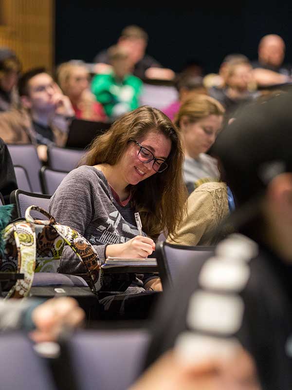 Students take notes during a lecture at Indiana University.