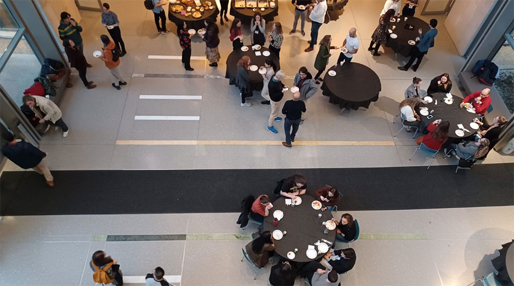 An overhead shot of people eating in the SGIS building.