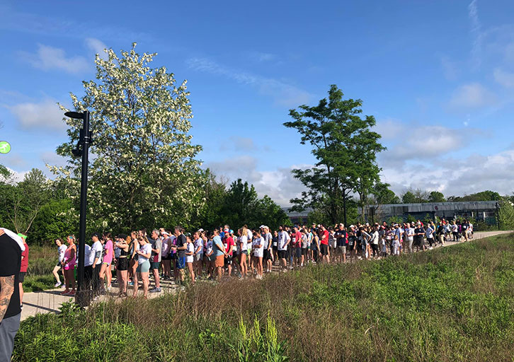 A group of people run in a 5K.